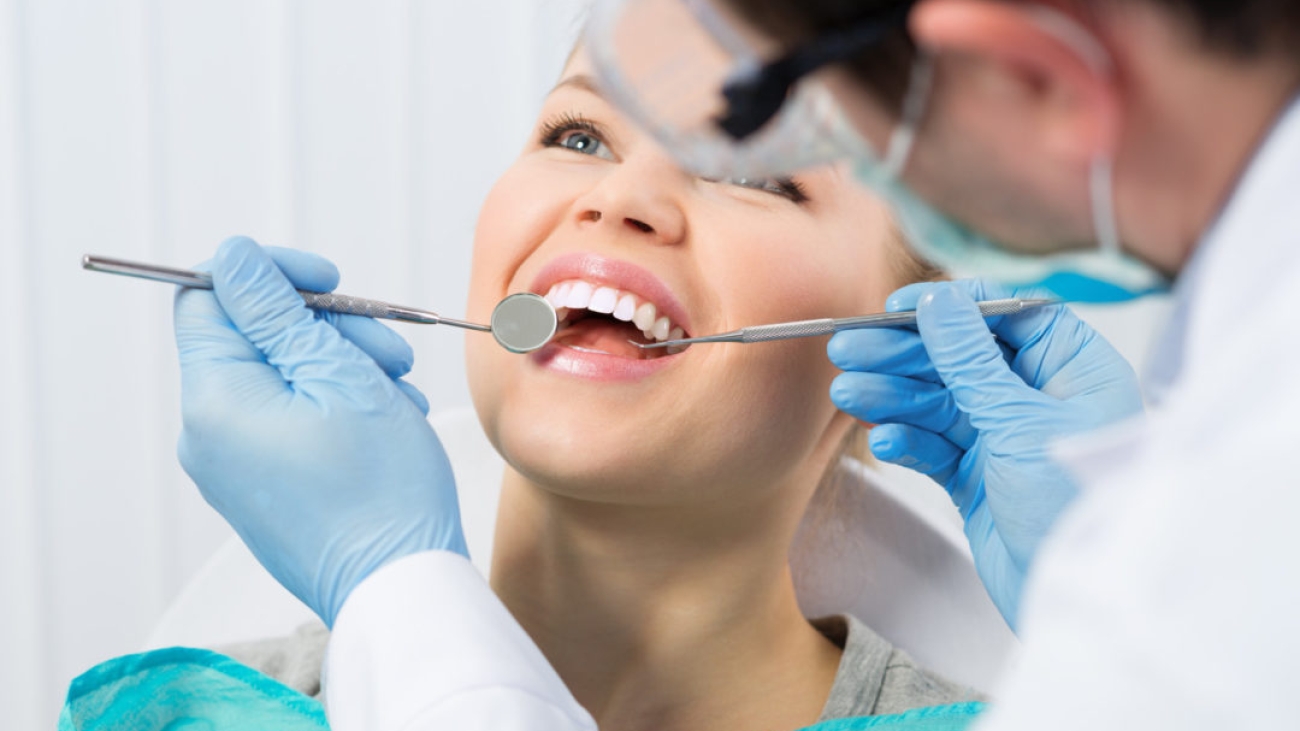 Regular dentist visit. Caries cure. Young woman visiting dentist